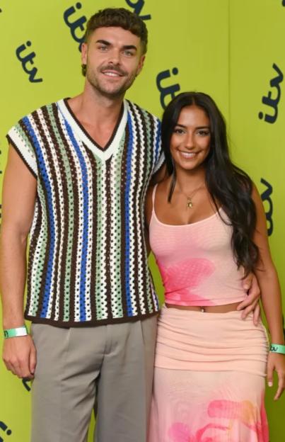 A smiling man and woman posing for a photo.