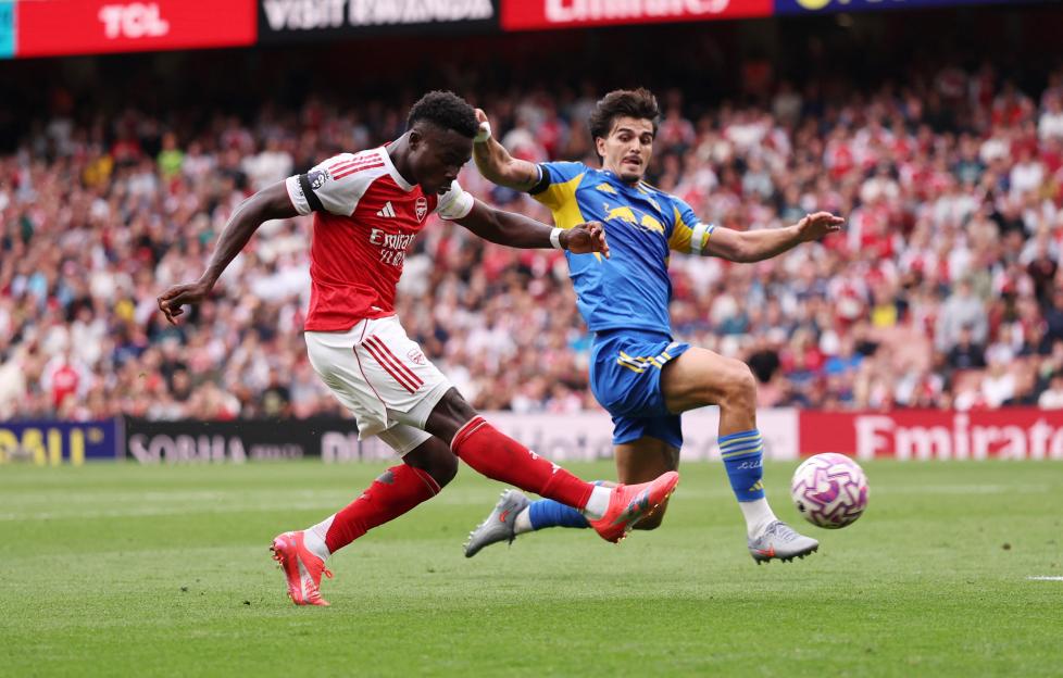 Bukayo Saka scoring a goal during a soccer match.