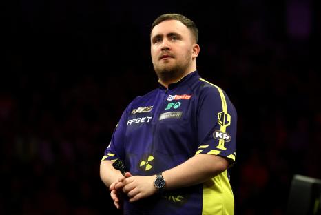 Luke Littler reacting during a darts match.