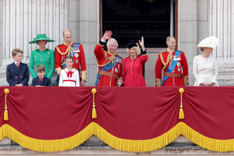 The royal family on a balcony waving.
