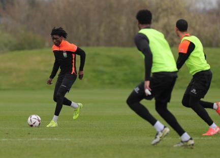 Soccer players practicing on a field.