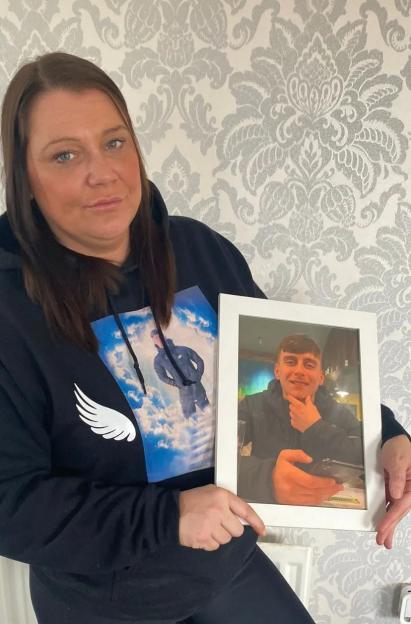 Nicole Wardle holding a framed photo of Dylan Keelan.