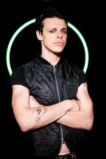 Yungblud backstage at a concert, arms crossed.