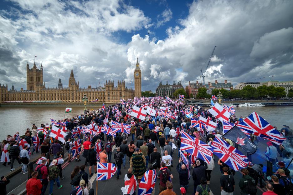 Protesters holding Union Jack and St George's England flags during the "Unite The Kingdom" rally on Westminster Bridge.
