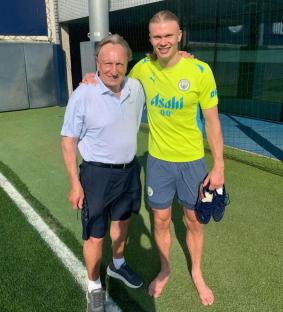 Erling Haaland and Neil Warnock on a soccer field.