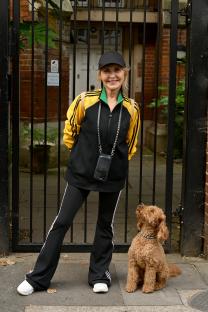 Woman and her cockapoo dog participating in a sponsored walk.