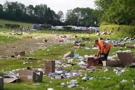 A person cleans up rubbish in a field after the Appleby Horse Fair.