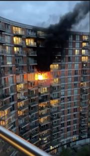 Huge fire erupts at tower block opposite O2 arena as black smoke billows from flat into the sky