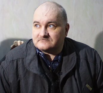 Portrait of a man in a dark jacket.