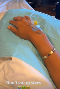 Woman's arm with IV in hospital bed; warning against eating oysters.