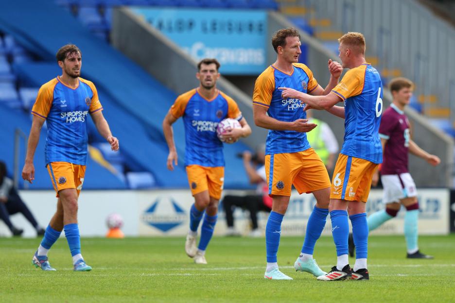 Shrewsbury Town players celebrating a goal.