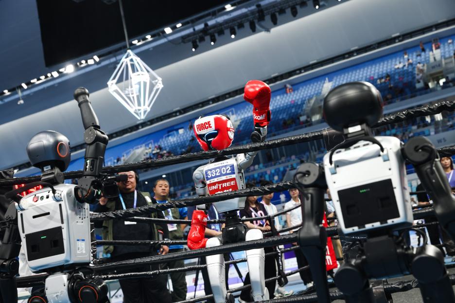 Humanoid robot boxing at a competition.
