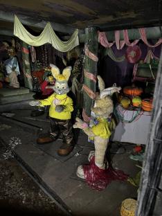 Two rabbit statues in an abandoned theme park tunnel.