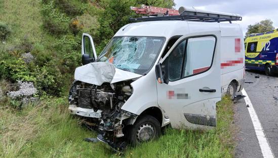 Damaged van at the scene of a fatal motorcycle accident.