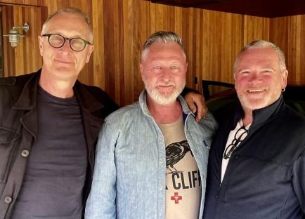 Three men posing for a photo.