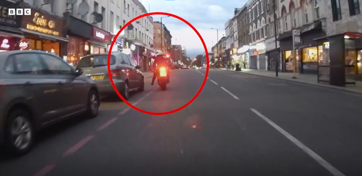 Screengrab of a motorcycle on a city street.
