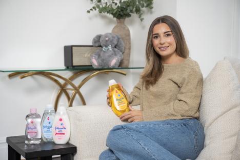 Dani Dyer holding Johnson's baby products.