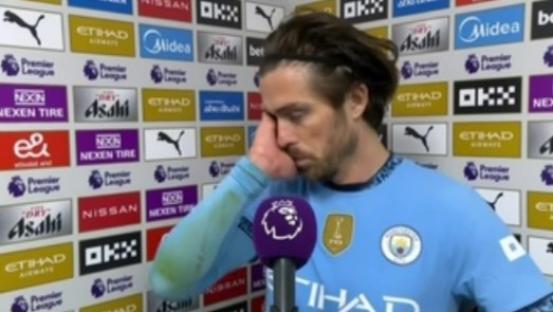Jack Grealish wiping away tears during an interview.
