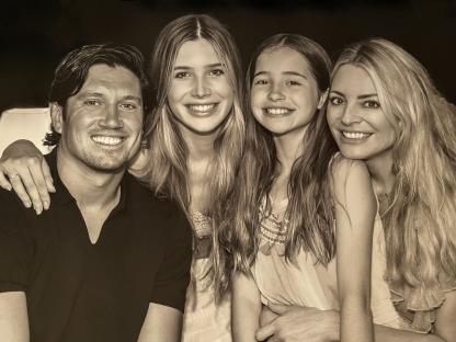 Sepia-toned family portrait of Tess Daly, Vernon Kay, and their two daughters.