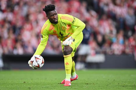 Andre Onana, Manchester United goalkeeper, holding a soccer ball.