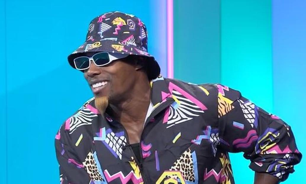 Man wearing 90s-style bucket hat and jacket.