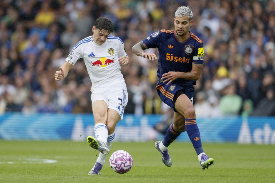 Daniel James of Leeds United and Bruno Guimarães of Newcastle United competing for the ball.