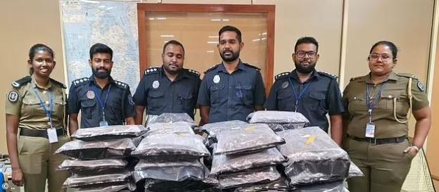 Police officers standing with confiscated drugs.