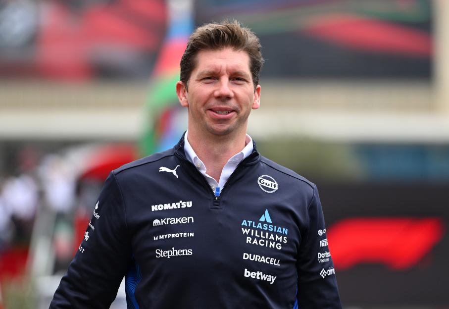 James Vowles, Team Principal of Williams, smiling in a sponsored navy blue jacket.