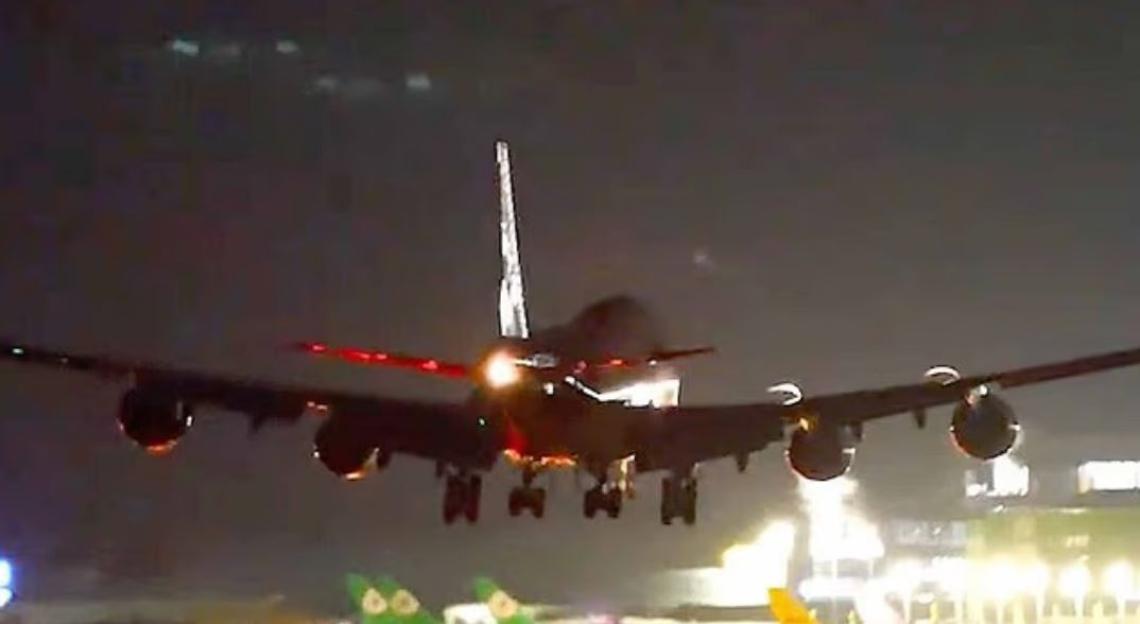 Boeing 747 wing hitting runway during landing.