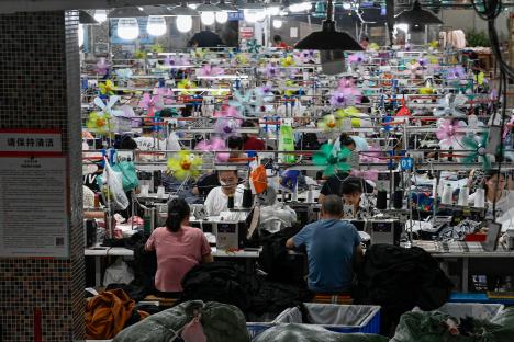 Workers sewing garments in a textile factory.