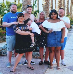 Photo of a family posing for a picture.