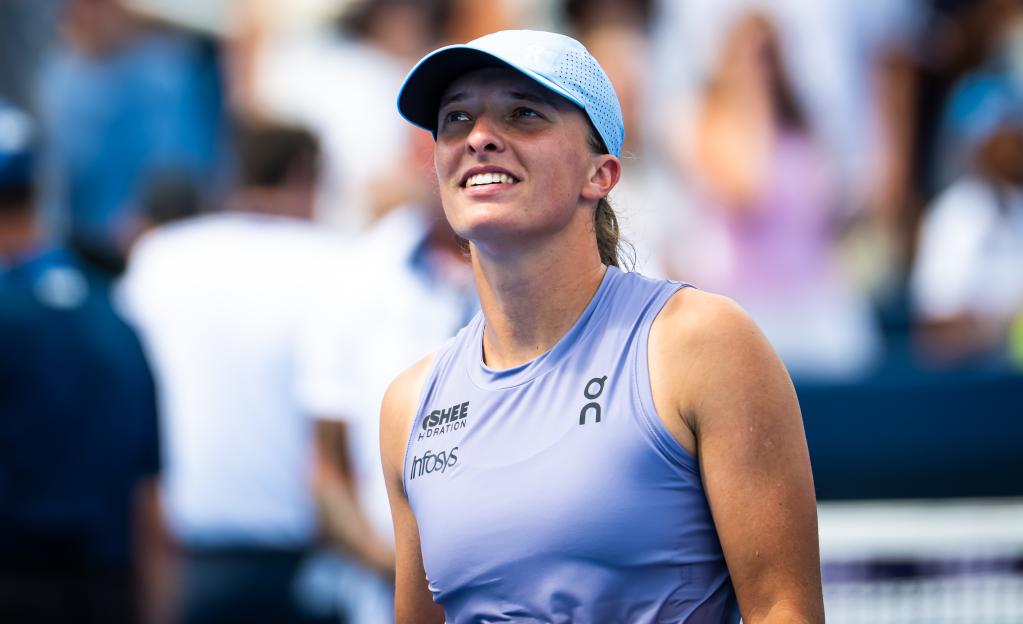 Iga Swiatek of Poland celebrating a tennis victory.