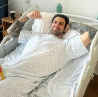 Man recovering in hospital bed after back surgery.
