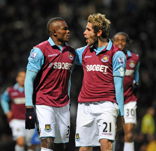 West Ham United players Victor Obina and Valon Behrami celebrating a goal.
