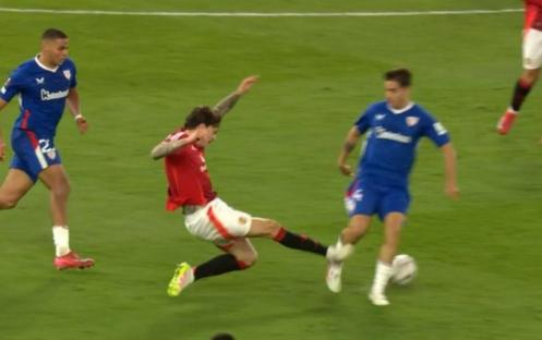 Soccer player sliding into another player's legs.