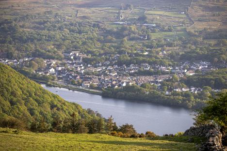 Aerial view of Llanberis, Wales, situated at the base of Dinorwig mountain with Llyn Padarn lake separating the town and mountain.