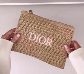 Tan Dior raffia clutch bag.