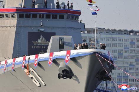 Kim Jong Un and his daughter attending the launching ceremony of a new North Korean destroyer.