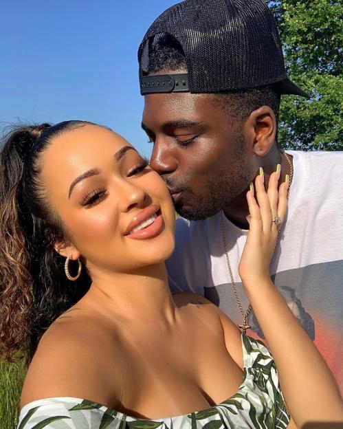 Marcel Somerville kissing his fiancée Rebecca Vieira.