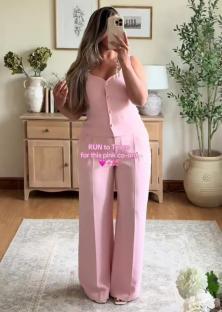 Woman in a pink pantsuit.