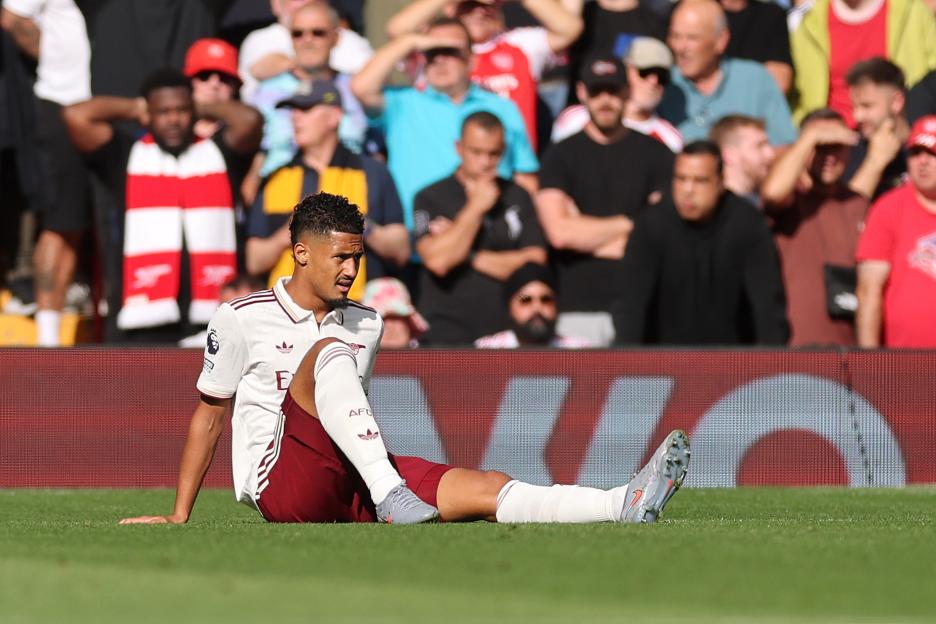 Arsenal's William Saliba reacts to an injury during a match.