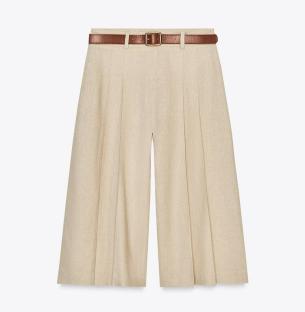 Beige linen culottes with a brown belt.