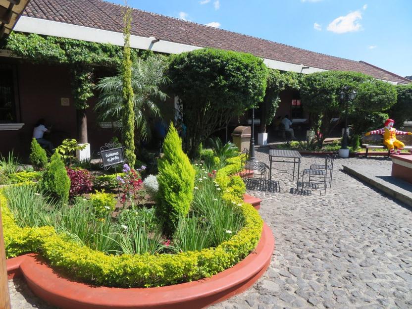 McDonald's courtyard with a garden and seating.