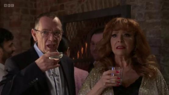 EastEnders characters drinking at a party.