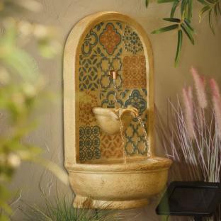 Wall-mounted fountain with patterned tile design.