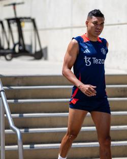Casemiro walking up stairs in a Manchester United training kit.