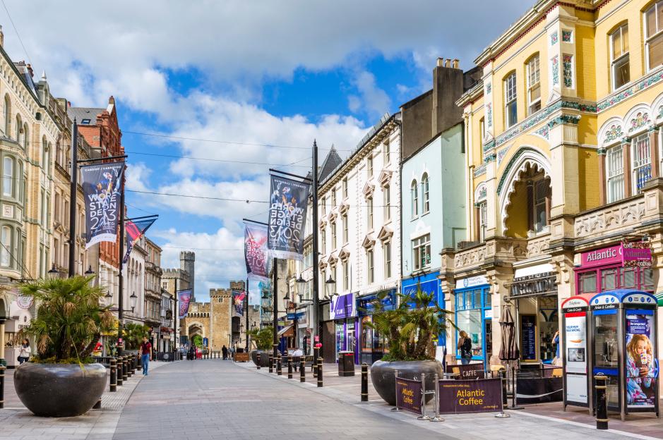 Shops on High Street looking towards Cardiff Castle, Cardiff, South Glamorgan, Wales, UK.