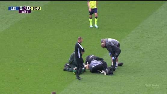 Injured soccer player receiving medical attention on the field.