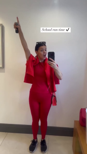Woman in red outfit taking selfie, celebrating school run.
