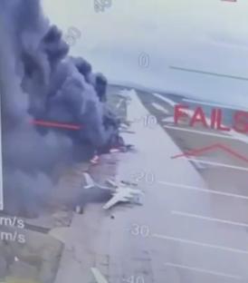 Laptop screen showing a burning Russian bomber.